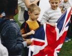 Group of kids holding a UK flag