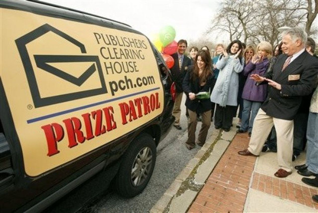 Publishers Clearing House prize patrol van surrounded by locals